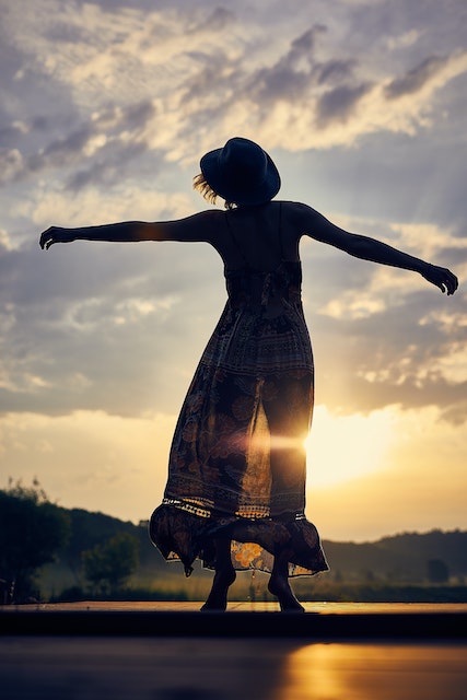 Image of woman under the sky 'letting go'.