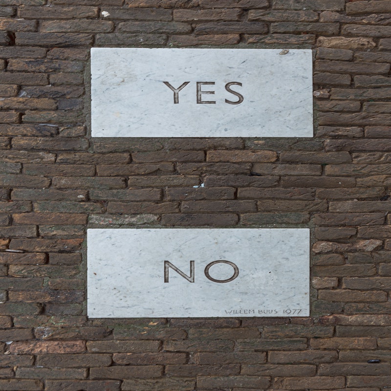 Image of brick wall with 'yes' or 'no' words.