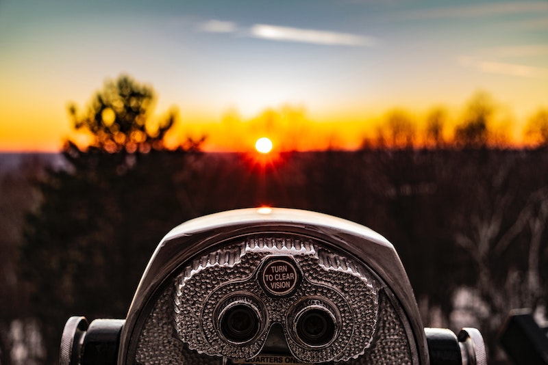 Image of binoculars looking into the distance.